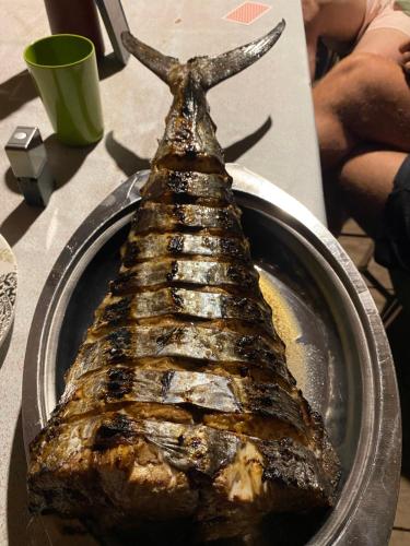 a piece of meat in a pan on a table at Fakriba tour camping and travel in Pulau Saonek-kecil