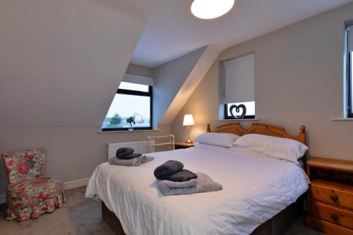 a bedroom with a large bed with towels on it at Finest Retreats - Kingsley Hollows Cottage in Kingsley