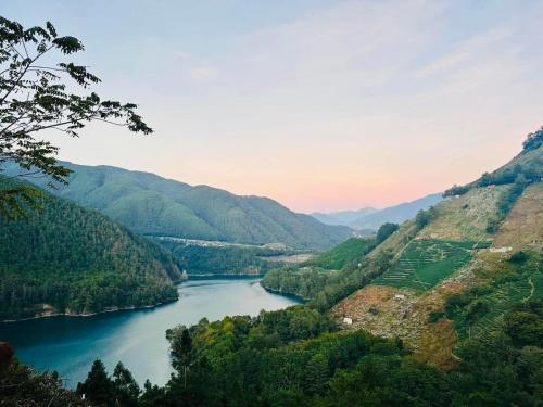 a view of a river in a valley with mountains at Lishan House in Heping