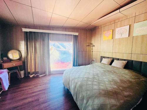 a bedroom with a large bed and a window at Lishan House in Heping
