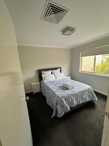 a bedroom with a bed and a window at Rehoboth homes in The Vines