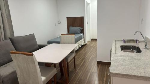 a living room with a table and a couch at Stunt Residence Hotel in Sao Paulo
