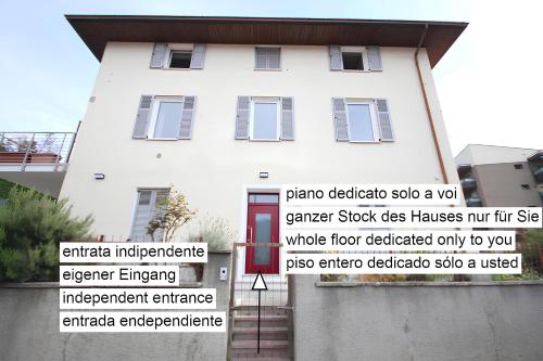 a white house with different parts of it at Over the Castle Apartment in Trento