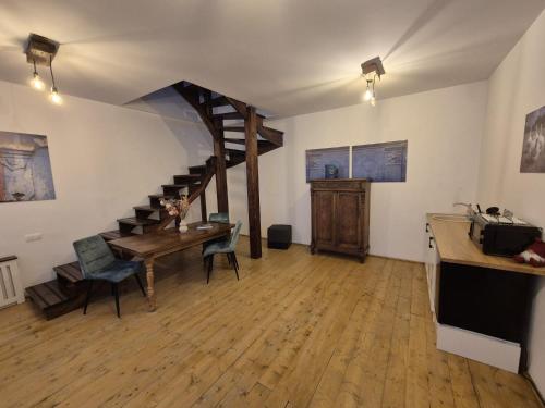 a living room with a staircase and a table and chairs at Zengő in Miercurea-Ciuc