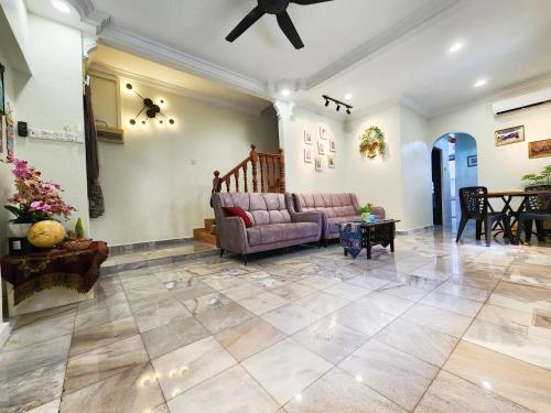 a living room with a couch and a table at Ipoh 168 Taman Pelangi, Persiaran Halaman Ampang Ipoh in Ipoh