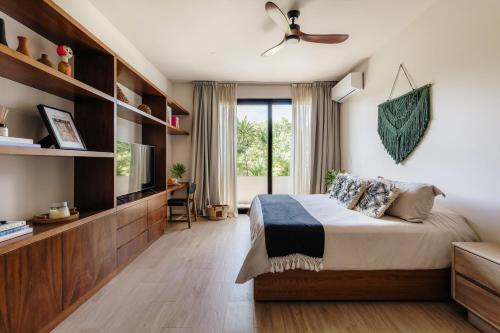 a bedroom with a large bed and a tv at Luxury Modern Villa Puerto Aventuras - Rivera Maya in Puerto Aventuras