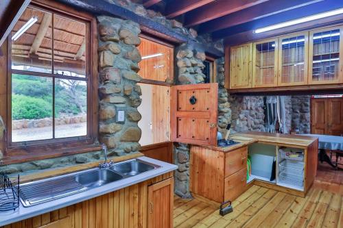 a kitchen with wooden cabinets and a sink at Green Silence in McGregor