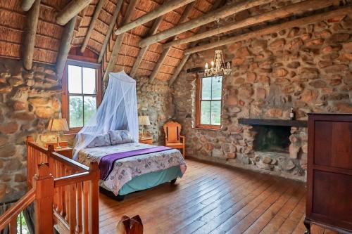 a bedroom with a bed in a stone building at Green Silence in McGregor