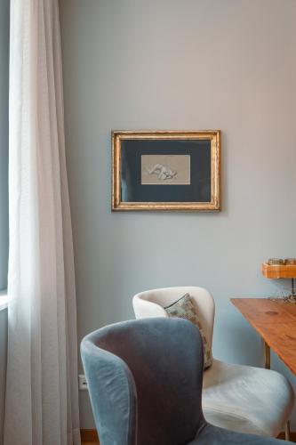 a living room with a chair and a picture on the wall at Alte Konditorei in Lindau