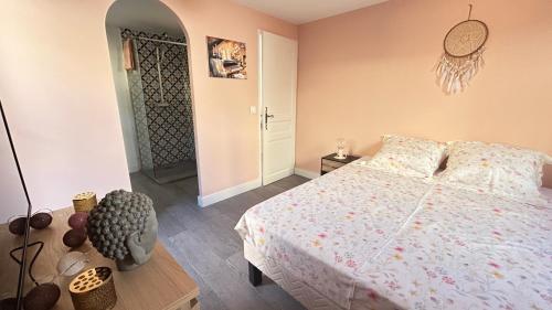 a bedroom with a bed with a white bedspread at Chambres d'hôtes Les Nymphéas in Revest-les-Roches