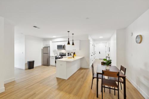 a white kitchen and dining room with a table and chairs at Market View Residence 604 I 2 Bedroom 2 Bathroom in Wilmington
