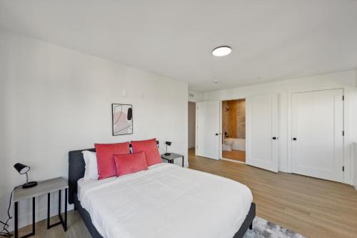 a bedroom with a large white bed with red pillows at Market View Residence 604 I 2 Bedroom 2 Bathroom in Wilmington