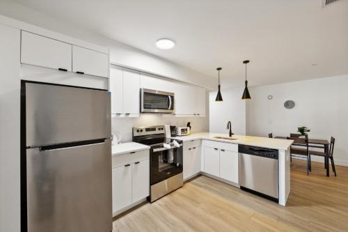 a kitchen with white cabinets and a stainless steel refrigerator at Market View Residence 604 I 2 Bedroom 2 Bathroom in Wilmington