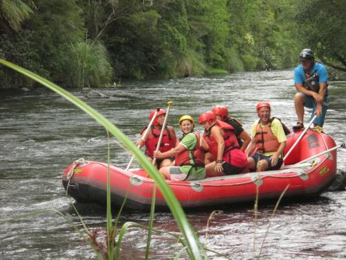 a group of people in a raft on a river at Tarawera River Lodge Motel in Kawerau
