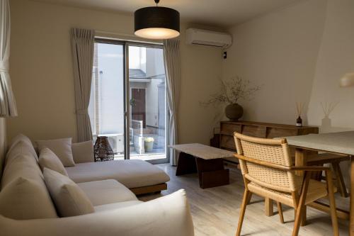 a living room with a couch and a table at 八万の宿 in Osaka