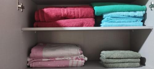 a closet filled with different colored towels at Apartment mit schöner Aussicht & Komfort in Obligado
