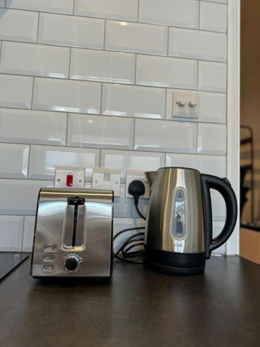 a coffee maker and toaster sitting on a table at 1 bed flat in central Cambridge in Cambridge