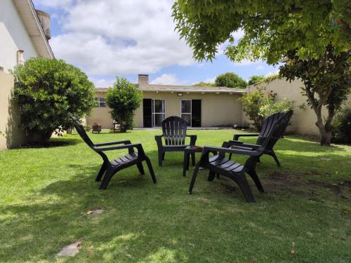 three chairs and a table in a yard at Ph Completo Petfriendly in Mar del Plata