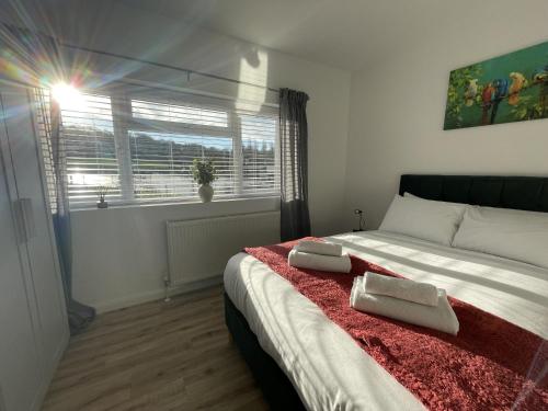 a bedroom with a bed with two towels on it at Inviting Urban Retreat in Avonmouth