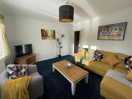 a living room with two couches and a coffee table at Inviting Urban Retreat in Avonmouth
