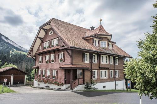 a large wooden house with a roof at Refugio Heiligkreuz in Hasle