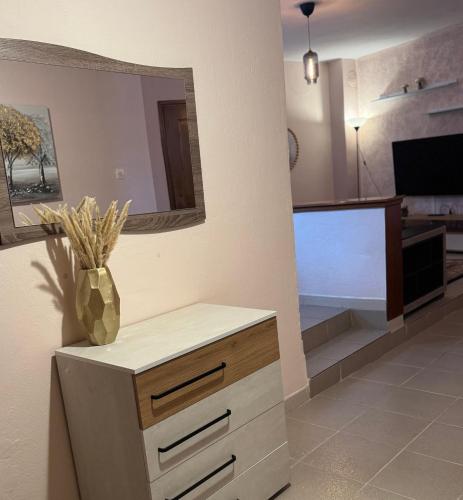 a living room with a dresser and a mirror at Near the lake in Kastoria