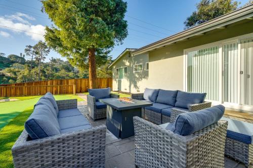 a patio with wicker furniture and a table at 2 Mi to Beach Home with Patio in Del Rey Oaks! in Del Rey Oaks