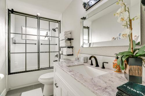 a white bathroom with a sink and a toilet at 2 Mi to Beach Home with Patio in Del Rey Oaks! in Del Rey Oaks