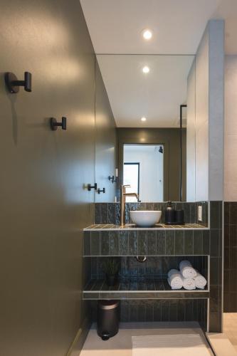 a bathroom with a sink and a mirror at Landskäp - Panoramic View With Spa Near Quebec City in Lac-Beauport
