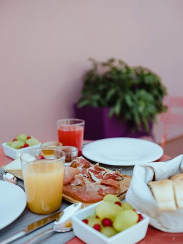 a table with plates of food and glasses of orange juice at Villa Verlengia in Montesilvano