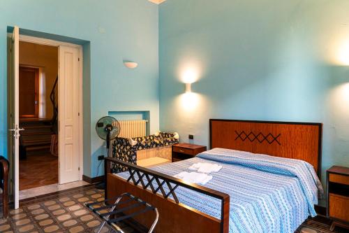 a bedroom with a bed and a chair in it at Relax on the Sea in Pizzo