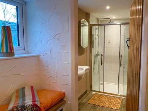 a bathroom with a walk in shower and a glass shower stall at Pass the Keys Dene Cottage - Perfect for 8 & Pets in Youlgrave in Youlgreave
