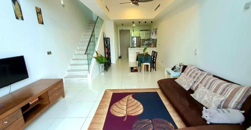 a living room with a couch and a flat screen tv at M CITY AMPANG, KLCC pool view in Kuala Lumpur