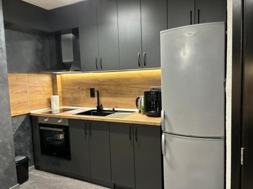 a kitchen with a white refrigerator and a sink at Апартамент 8 in Varna City