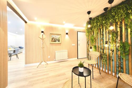 a living room with a wall of plants at Lucus Skyline & Terrace by Lugo Collection in Lugo