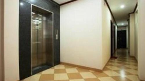 a hallway with a glass door in a building at Phú Mỹ in Phong Lộc
