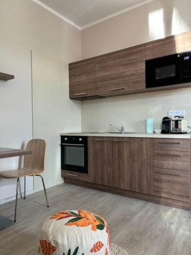 a kitchen with a sink and a stove top oven at Penzion Apartmány Resident in Poděbrady