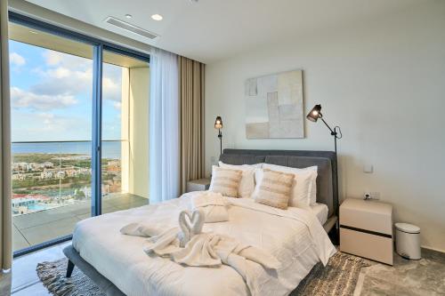 a bedroom with a large bed with a large window at Stunning Seaview Mercury Tower Apartments - Luxurious Twin Units in St. Julianʼs