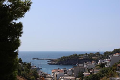 a view of a city and the ocean from a hill at Eleni's Guest House in Patitiri