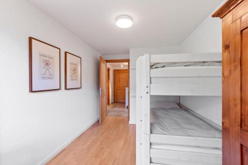 a room with two bunk beds and a hallway at Chalet apartment with balcony and Alpine view in Ollon