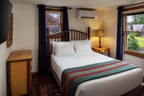 a bedroom with a bed and a window at Lodge at Schroon Lake in Schroon Lake