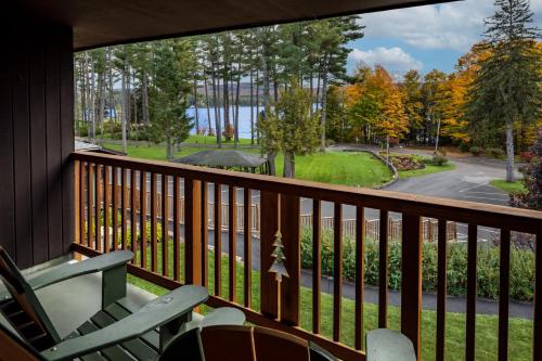 a balcony with a view of a road and trees at Lodge at Schroon Lake in Schroon Lake