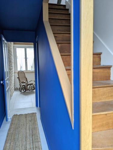 a blue stairwell in a house with a blue wall at La maison bleue in Dijon
