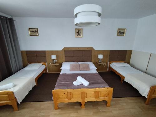 a bedroom with two beds with towels on it at Tatrzańska Panorama in Gliczarów