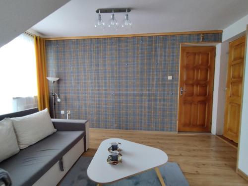 a living room with a couch and a table at Tatrzańska Panorama in Gliczarów