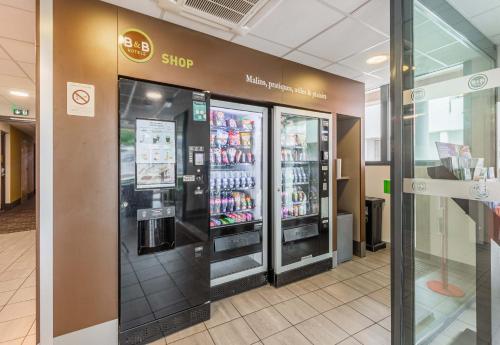 a store with two soda machines in a store at B&B HOTEL Mulhouse Centre in Mulhouse