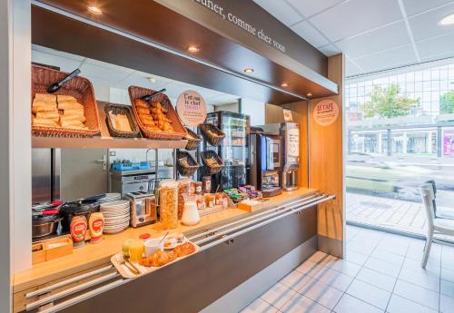 a bakery counter with bread and pastries in a store at B&B HOTEL Mulhouse Centre in Mulhouse