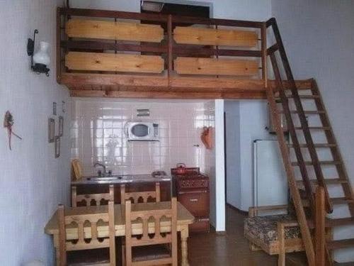 圣贝尔纳多Departamento de 2 ambientes y medio c/entrada de auto的一间厨房,在房间内配有高架床