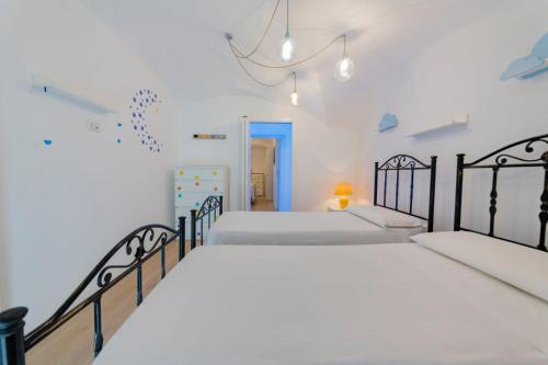 a bedroom with two beds and a hallway at Holiday Home San Lazzaro in Lecce