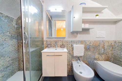 a bathroom with a sink and a toilet and a shower at Holiday Home San Lazzaro in Lecce
